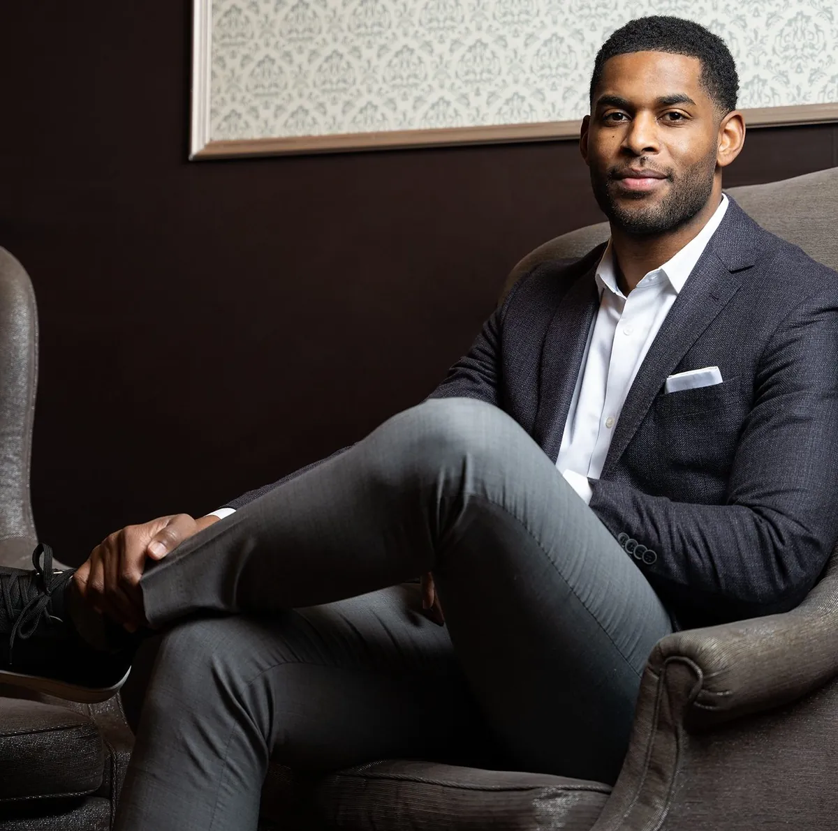 Marques Colston seated in an armchair